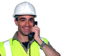 smiling construction worker with a phone