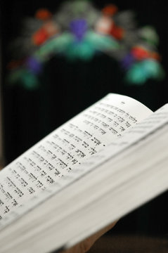  Hebrew prayer book against a backdrop of a Holy Ark curtain