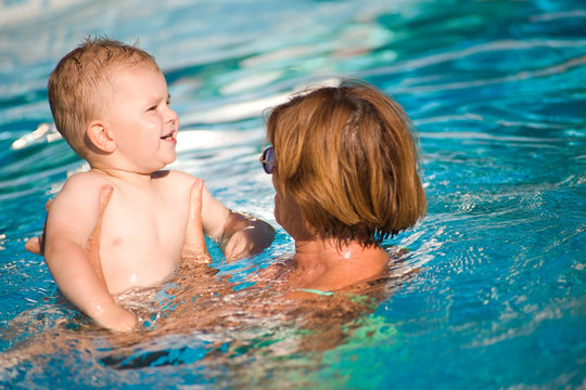 Grandmother swimming with grandson