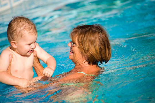 Grandmother swimming with grandson