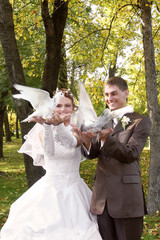bride and groom with two doves