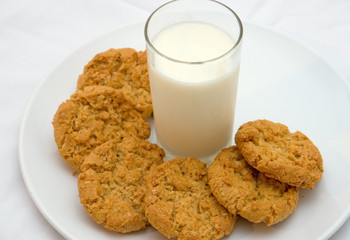 plate of cookies and glass of milk on isolated white plate