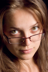 Face of young woman with glasses close up  