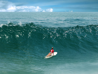 Young girl surfing on Malibu Beach, California