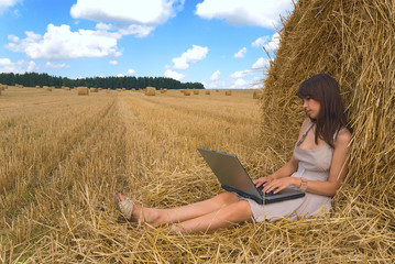 Naklejka na ściany i meble The girl behind a laptop