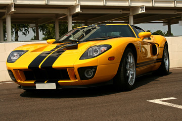 front of yellow supercar with black stripes