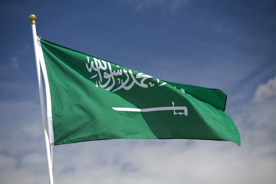 Saudi Arabian Flag Flying Against A Blue Sky