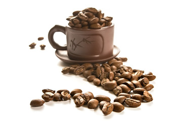 Coffee grains in brown cup