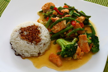 Hot thai food - salmon with rice and vegetables