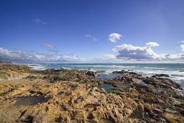 Fototapeta na wymiar Seascape with rocks and deep blue sky