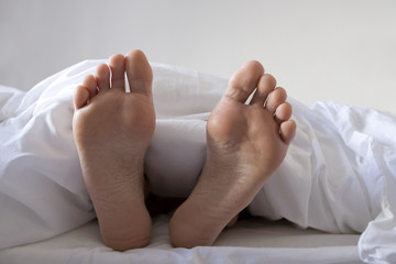 bare feet of a sleeping man
