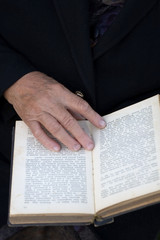 Naklejka premium Senior's hands on old Bible
