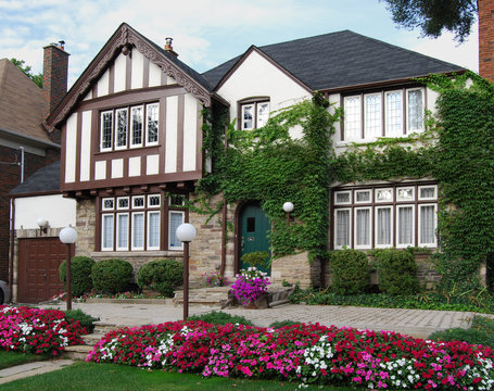 Ivy covered tudor style two storey house with impatiens