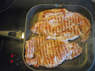 Steaks on a frying pan