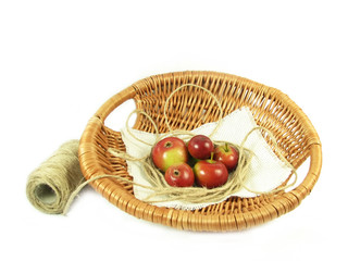 red apple in basket and string on white