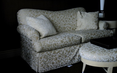Neutral patterned sofa with matching ottoman and tea tray 