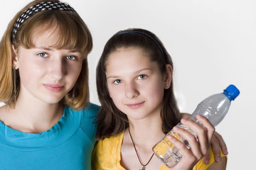 Two young girls with bottle of fresh water