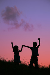 children silhouette on sunset