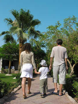 family walking in the tropical garden