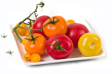 Red, orange and yellow tomatoes on the vine
