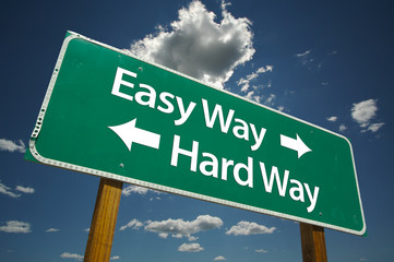 Easy Way, Hard Way Road Sign with dramatic blue sky and clouds.