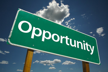 Opportunity Road Sign with blue sky and clouds.