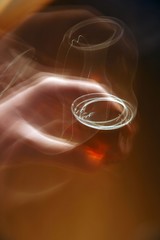 blurred hand holding a glass