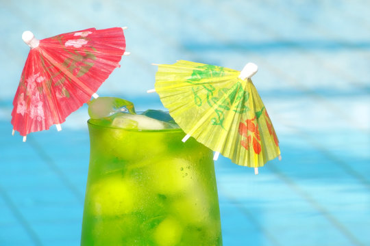 Green cold tropical drink by a pool