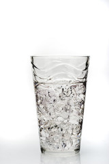 a glass with crashed ice isolated on white background
