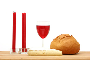 Red wine, bread, cheese and candles
