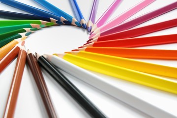 Assortment of colored pencils with shadow on white background 