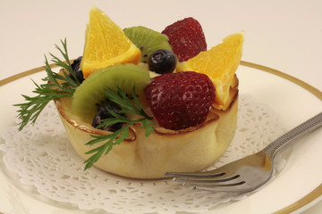 Fresh fruits bowl cake on white background