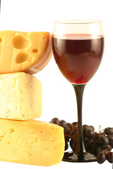 Grapes, cheese and a glass with red wine isolated on white.