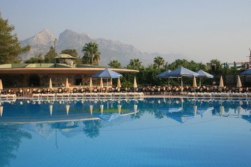 Fototapeta na wymiar Pool and a bar on a background of mountains.