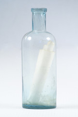 Paper scroll with message in the bottle