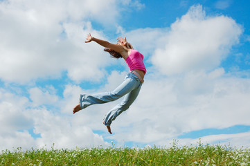 Jumping girl on the meadow