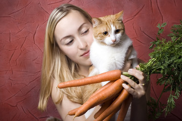 Woman and her cat with carrots