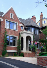 Large red brick house with cedar roof