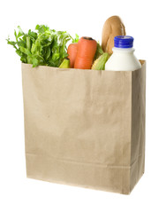 Paper bag full of groceries isolated on white background