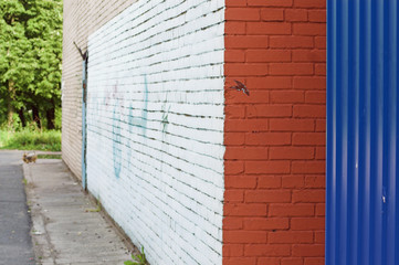 Close-up view of corner and painted wall with graffiti