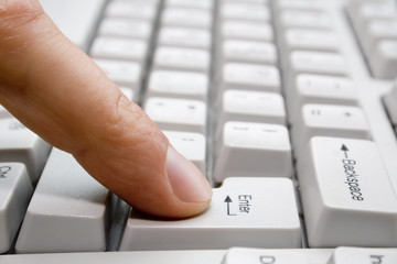 finger presses the key