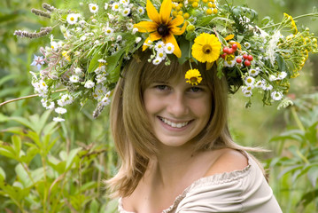 girl with flower wreath in the meadow