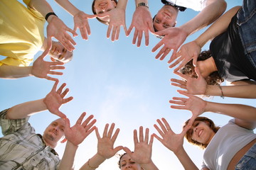 group of people make cyrcle from hands