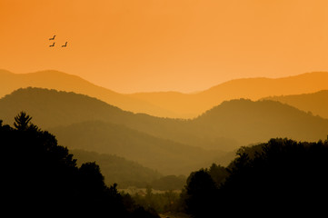 Serene sunrise over a distant mountain