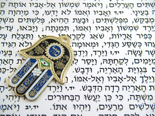 Blue Hamsa kabala good luck charm on Hebrew bible © samc