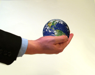 Businessman holding planet earth in his hand