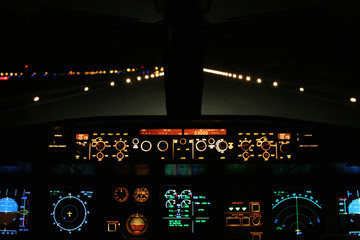 aircraft landing at night with runway ahead
