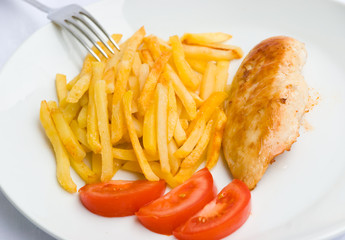 baked chicken breast  with french fried potatoes