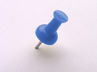 multicolored push pins on white - blue