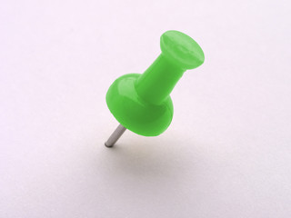 multicolored push pins on white - green
